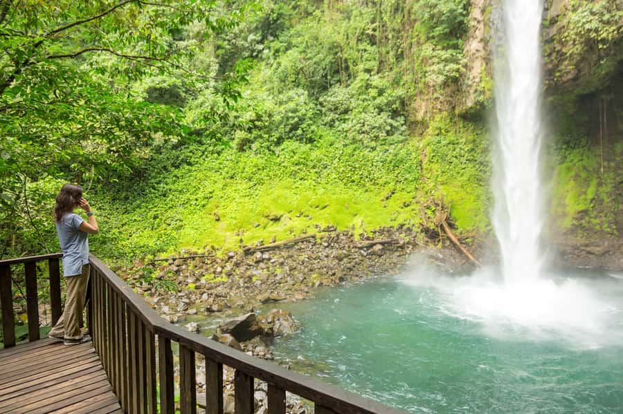 Bali Waterfall Tour with Lunch Views of Mount Batur - Kanto Lampo Waterfall: broad rocks and playful water