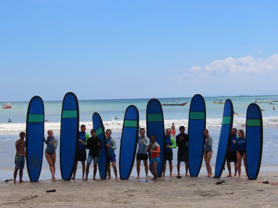 Surfboards racked on the beach before the morning lesson
